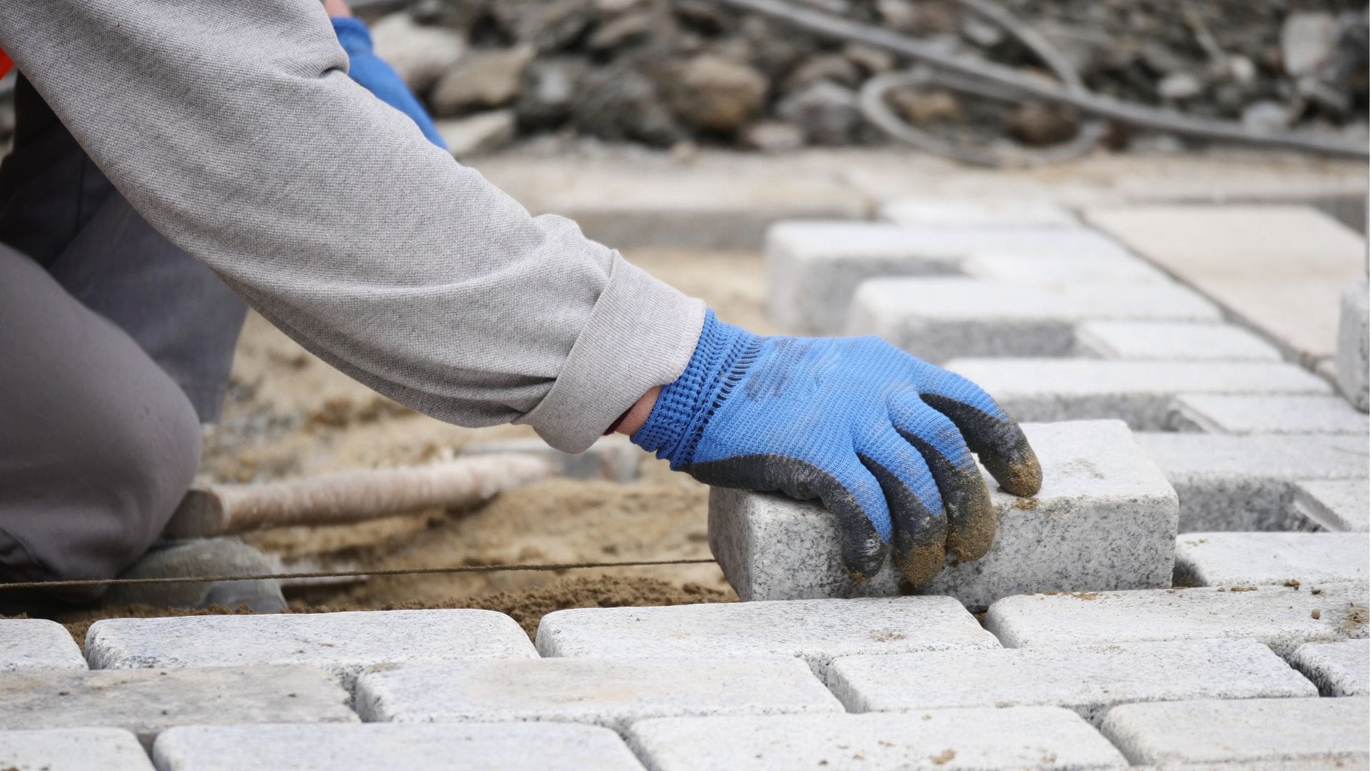 Person laying stones on ground